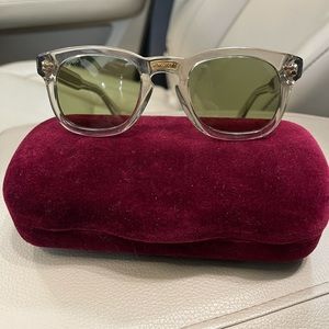 Gucci sunglasses clear frames with gold accents and green shades